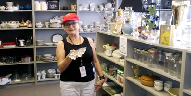 Person holding a thrifted item in the Vichy's values store